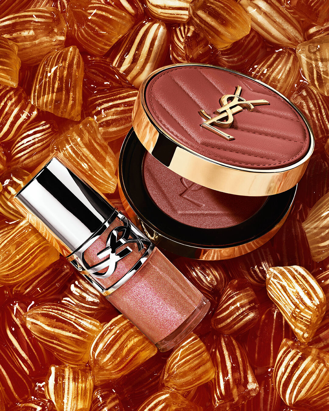YSL LOVESHINE Plumping Lip Oil Gloss shade 12 and Make Me Blush shade 12, nestled among golden berlingot sweets.