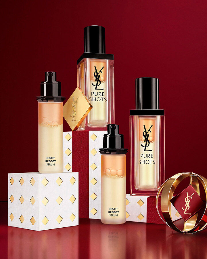 YSL Pure Shots skincare serums displayed on white and gold Holiday gift packaging.