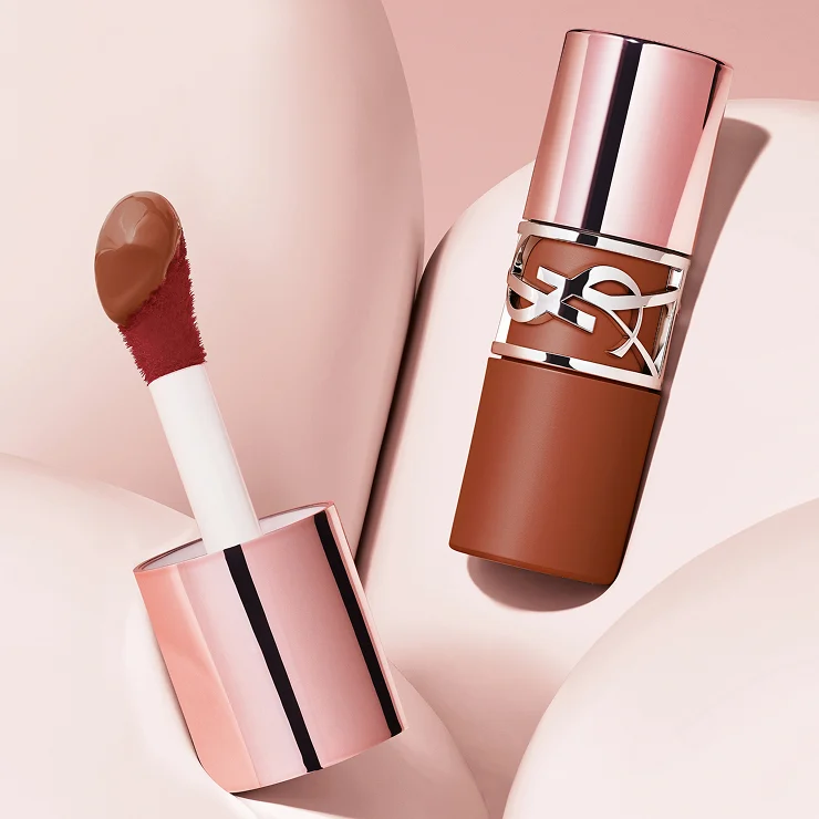 Detailed YSL LOVENUDE LIP STAIN bottle
with signature wide applicator and serum
texture on pink backgraound