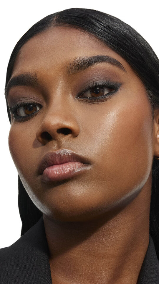 Mira, fair-skinned, with YSL LOVESHINE Plumping Lip Oil Gloss in Shade 10 Stardust Love, showcasing glossy lips.